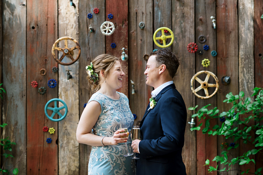 A newly married couple celebrate with champagne after their wedding ceremony at Talula's Garden in Philadelphia.